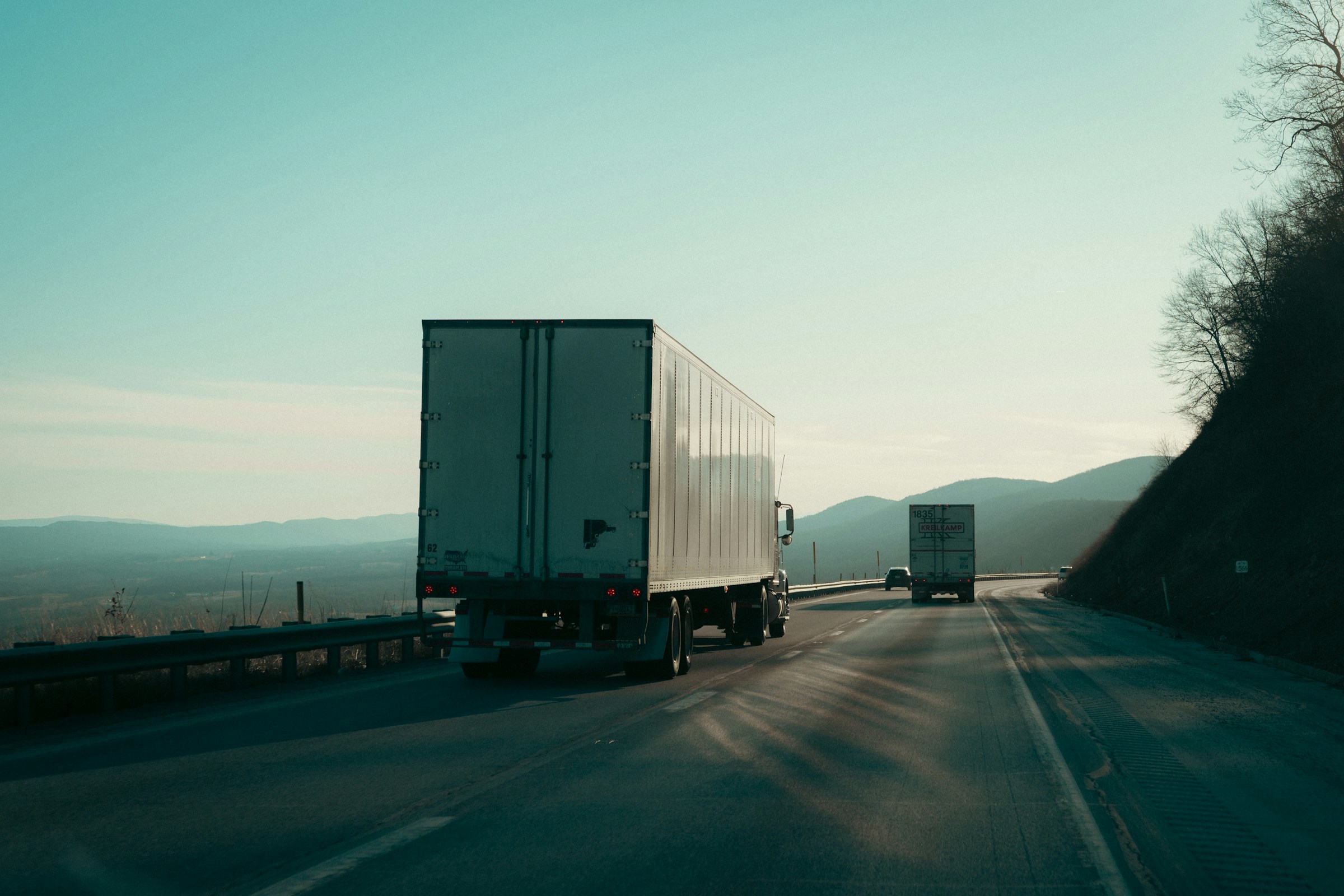 Freight trucks travelling through the mountains on a highway